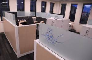 A cartoon sketch is seen on a cubicle in the offices of the Alaska Permanent Fund Corp. during an open house on Friday, Feb. 16. (James Brooks/Alaska Beacon)