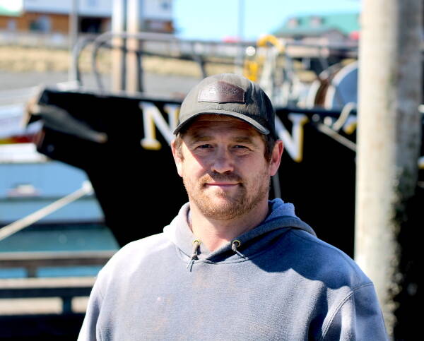 Scotty Switzer, 36, poses for a photo on his boat at the Homer harbor. (Nathaniel Herz/Northern Journal)