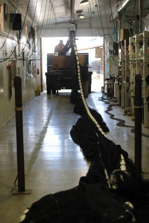 Workers at a Homer boatyard load a net for shipment last month. The downturn in Alaskas fishing industry has hit not just fishermen and processing companies but also other maritime businesses. In Homer, supply company Nomar Alaska got two orders of specially designed fish bags during a November fishermens convention  down from 25 to 30 orders in a normal year. Were feeling it, said Jennifer Hakala, Nomars office manager. (Nathaniel Herz/Northern Journal)