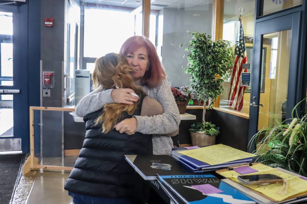 Ginalyn Del Rosario, a 2017 Thunder Mountain High School graduate, hugs former teacher Janna Lelchuk on Monday. (Jasz Garrett / Juneau Empire)