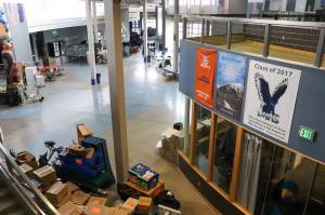 Juneau School District maintenance and custodial crew work on transitioning Thunder Mountain High School to Thunder Mountain Middle School on Monday. (Jasz Garrett / Juneau Empire)
