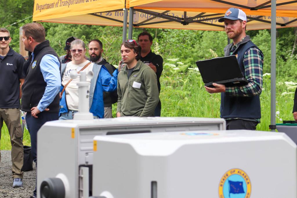 Pat Dryer, avalanche and geohazards specialist for the Southcoast Region of Department of Transportation, opens DJI dock one, the home of a mapping drone. (Jasz Garrett / Juneau Empire)