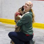 Ashlynn King, Juneau Animal Rescue clinic assistant, gets kisses from Aurora, a 12-week-old husky mix from Kake during a pet meet-and-greet Saturday at Treadwell Arena. (Jasz Garrett / Juneau Empire)