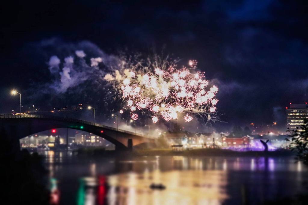 A firework shoots off over the Douglas Bridge. (Jasz Garrett / Juneau Empire)
