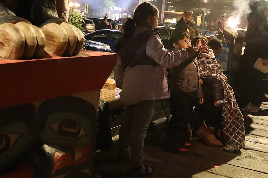 Danny Kivalu, 4, and his sister, Faye, 6, light sparklers on the downtown Juneau cruise ship dock shortly before midnight Thursday while waiting for the Fourth of July fireworks show to start. (Mark Sabbatini / Juneau Empire)