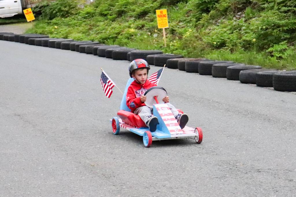 Garrett Reid takes his patriotic soapbox car for a spin during the challenge trials in Douglas on Wednesday. (Jasz Garrett / Juneau Empire)