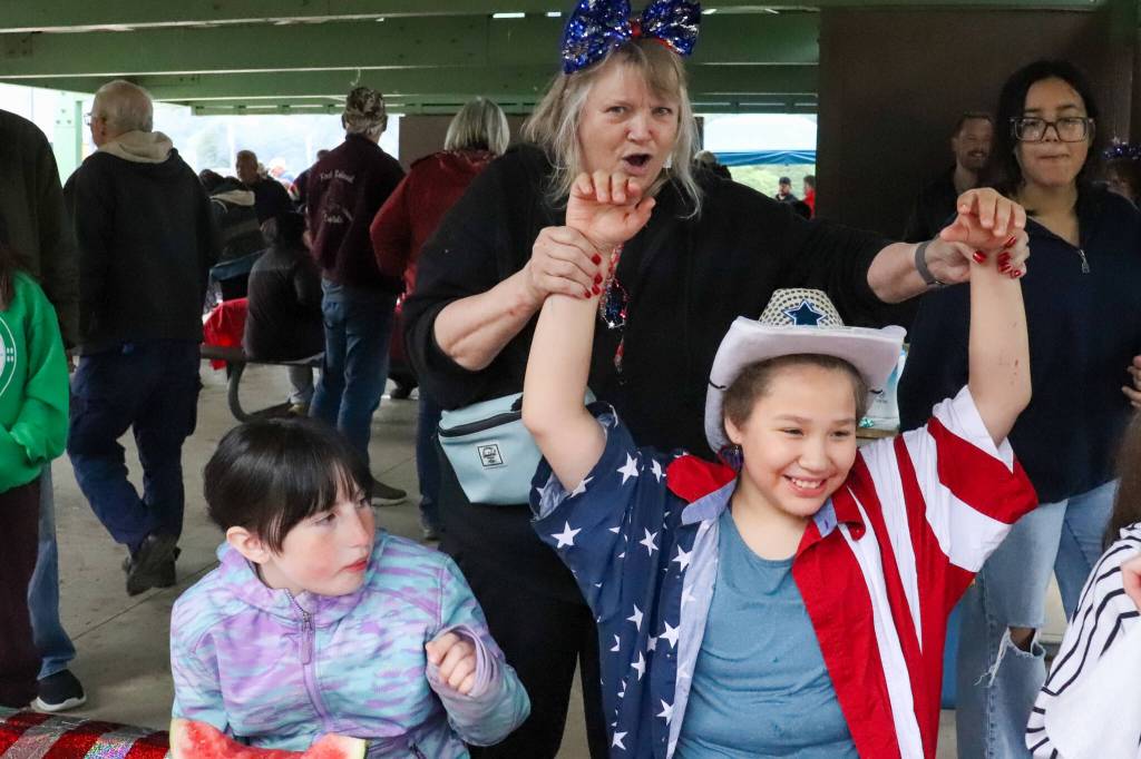Merry James, 10, a competitor in the July 3 watermelon-eating contest in Douglas for the past two years, celebrates her first win Wednesday. (Jasz Garrett / Juneau Empire)
