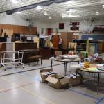 Items ranging from colored pencils to pianos to folding cafeteria tables are offered for sale  or giveaway to nonprofit entities  in the gym at the former Floyd Dryden Middle School on Saturday. (Mark Sabbatini / Juneau Empire)
