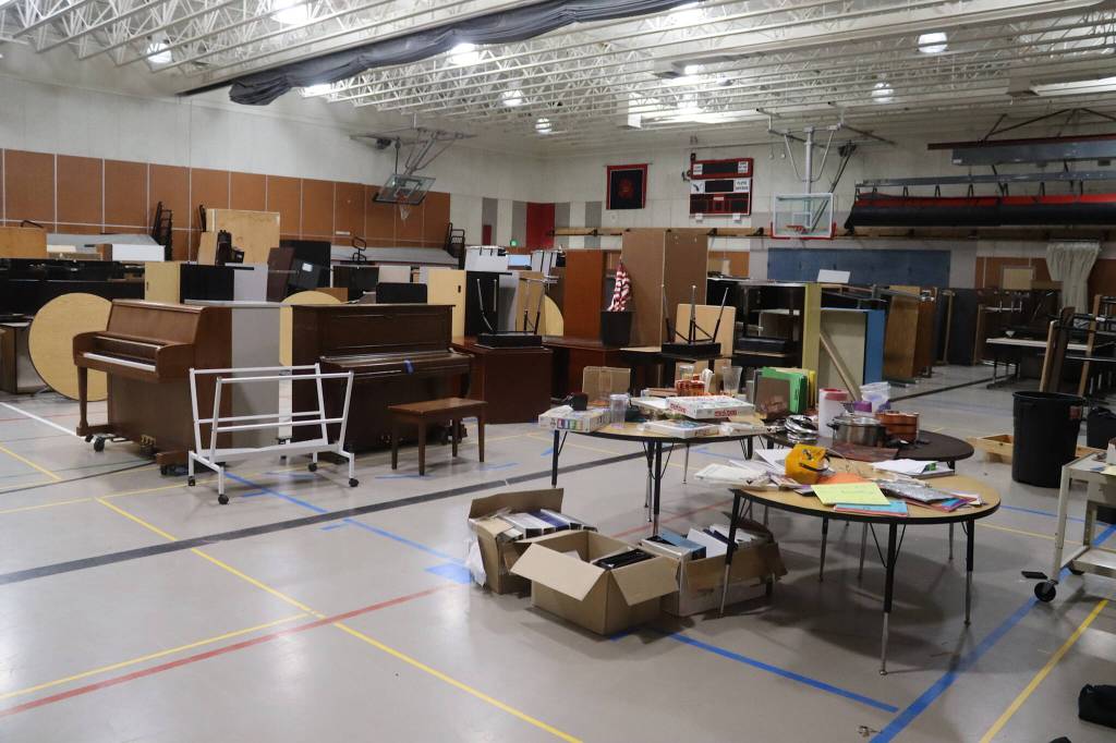 Items ranging from colored pencils to pianos to folding cafeteria tables are offered for sale  or giveaway to nonprofit entities  in the gym at the former Floyd Dryden Middle School on Saturday. (Mark Sabbatini / Juneau Empire)