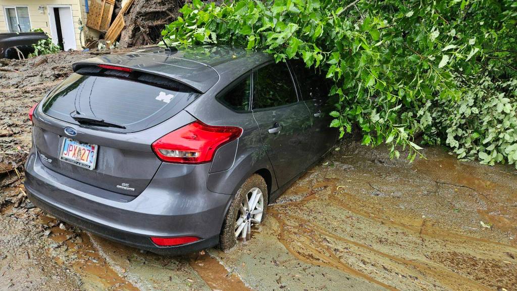 A car on Gastineau Avenue is partially buried by a mudslide that occurred at about 11 a.m. Sunday. (Photo by Simba Blackman)