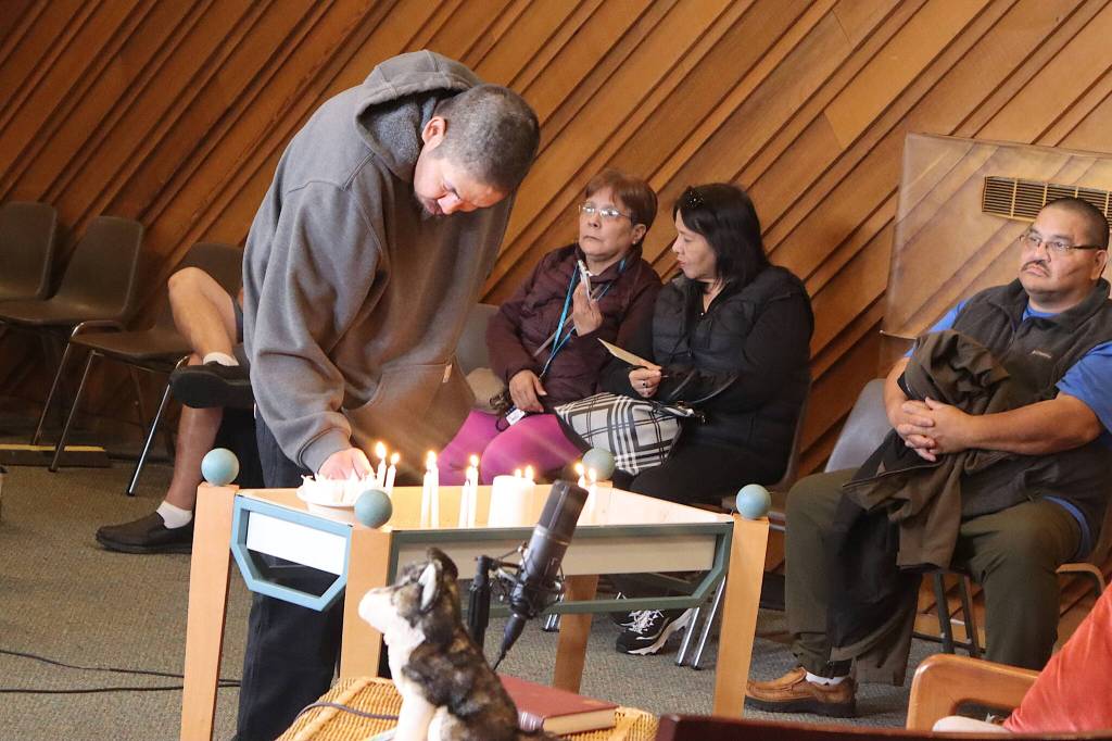A friend of Steven Kissack, a longtime Juneau resident experiencing homelessness who was fatally shot by police on Monday, lights candle during a vigil for him Tuesday evening at Resurrection Lutheran Church. (Mark Sabbatini / Juneau Empire)