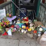 Items in memorial of Steven Kissack, a longtime Juneau resident experiencing homelessness who was fatally shot by police on Monday, are placed Tuesday in a doorway on Front Street that was one of his frequent sleeping spots. (Mark Sabbatini / Juneau Empire)