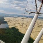 The Nogahabara Dunes spill into a lake 35 miles west of the village of Huslia as seen from the back seat of a Super Cub piloted by Brad Scotton of the U.S. Fish and Wildlife Service based in Galena. (Photo by Ned Rozell)