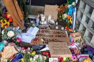 A memorial started on Front Street in downtown Juneau for 35-year-old Juneau resident Steven Kissack, who was experiencing homelessness, grows on Thursday with food donations and suicide hotline information. (Jasz Garrett / Juneau Empire)
