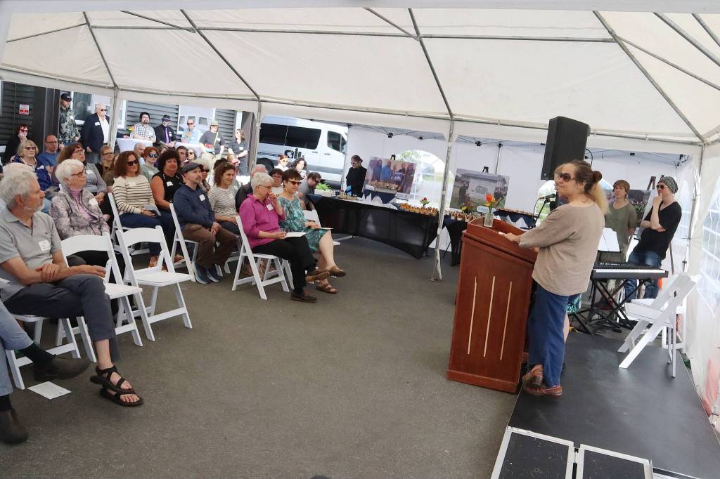 Glory Hall Executive Director Mariya Lovishchuk (foreground at right) and United Human Services of Southeast Alaska Executive Director Joan OKeefe speak to attendees at a ribbon-cutting ceremony for the Teal Street Center on Thursday afternoon. (Mark Sabbatini / Juneau Empire)