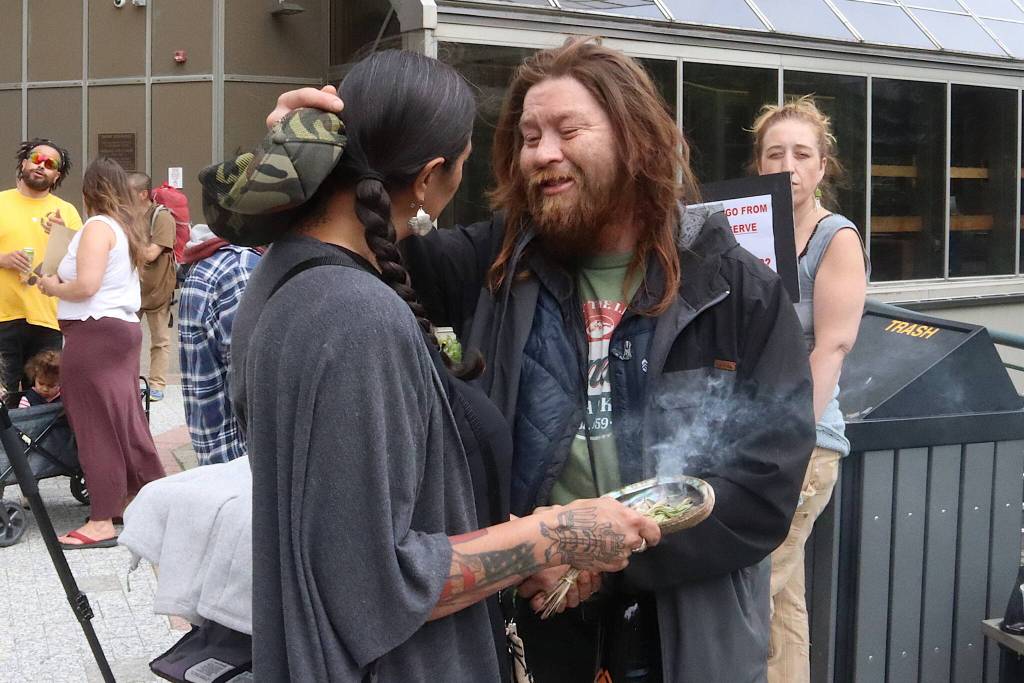 Jamiann Hasselquist and Jonathan James remember Steven Kissack during a protest held for him on Sunday. (Mark Sabbatini / Juneau Empire)