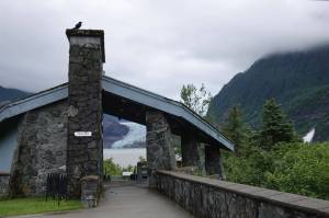 Cloudy sky silhouettes a solitary raven near Mendenhall Glacier Visitor Center early Tuesday morning as the bird perched atop the U.S. Forest Service pavilion framing the glaciers blue ice across Mendenhall Lake. (Laurie Craig / Juneau Empire file photo)