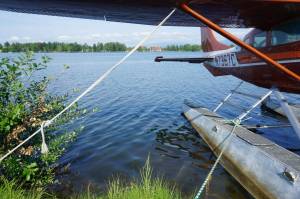 Waters of Anchorages Lake Hood and, beyond it, Lake Spenard are seen on Wednesday behind a parked seaplane. The connected lakes, located at the Ted Stevens Anchorage International Airport, comprise a busy seaplane center. A study by Alaska Community Action on Toxics published last year found that the two lakes had, by far, the highest levels of PFAS contamination of several Anchorage- and Fairbanks-area waterways the organization tested. Under a bill that became law this week, PFAS-containing firefighting foams that used to be common at airports will no longer be allowed in Alaska. (Yereth Rosen/Alaska Beacon)