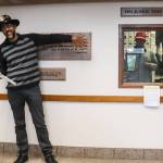 Jonathon Turlove, son of Michael Orelove, points at the 1994 Juneau Time Capsule inside the Federal Building on Friday for the 30th anniversary celebration. (Jasz Garrett / Juneau Empire)