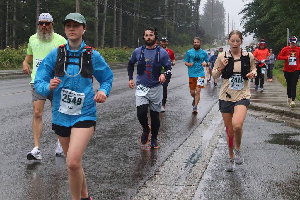 A crowd of runners proceeds along Douglas Highway during the Juneau Half Marathon on Saturday. The half-length course attracted more than twice as many participants this year as the full-length course. (Mark Sabbatini / Juneau Empire)