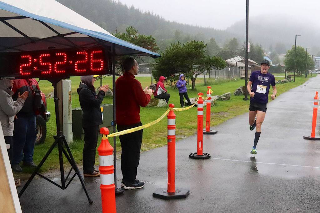 Connor Arnell lets out a victorious yell as he crosses the finish line to win the Juneau Marathon on Saturday at Savikko Park. (Mark Sabbatini / Juneau Empire)