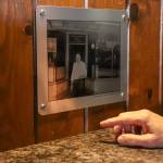 Leeann Thomas, the owner of the Triangle Club for the last 25 years, points at a photo of her grandfather and previous owner, Joe Thomas Sr. (Jasz Garrett / Juneau Empire)