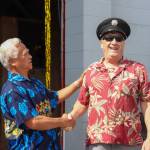 Retired Capital City Fire/Rescue Assistant Chief Ed Quinto shakes hands and laughs with retired CCFR paramedic Allan Edwards on Saturday. They first met when Quinto took his EMT class in 1979. (Jasz Garrett / Juneau Empire)