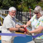 Mayor Beth Weldon cuts a ribbon for Capitol Parks opening Saturday with John Pugh, Juneau Park Foundation vice chair and Juneau Community Foundation board president. (Jasz Garrett / Juneau Empire)
