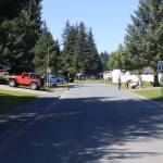 Residents on Meander Way gather around a stand selling drinks, cookies and handmade trinkets early Sunday afternoon, a few hours after a flood warning was issued for the neighborhood due to a glacier outburst flood from Suicide Basin. Residents along the street, whose homes and yards were infiltrated by water from record flooding last year, said they are making contingency plans as they keep an eye on the water, but not fleeing their homes yet. (Mark Sabbatini / Juneau Empire)