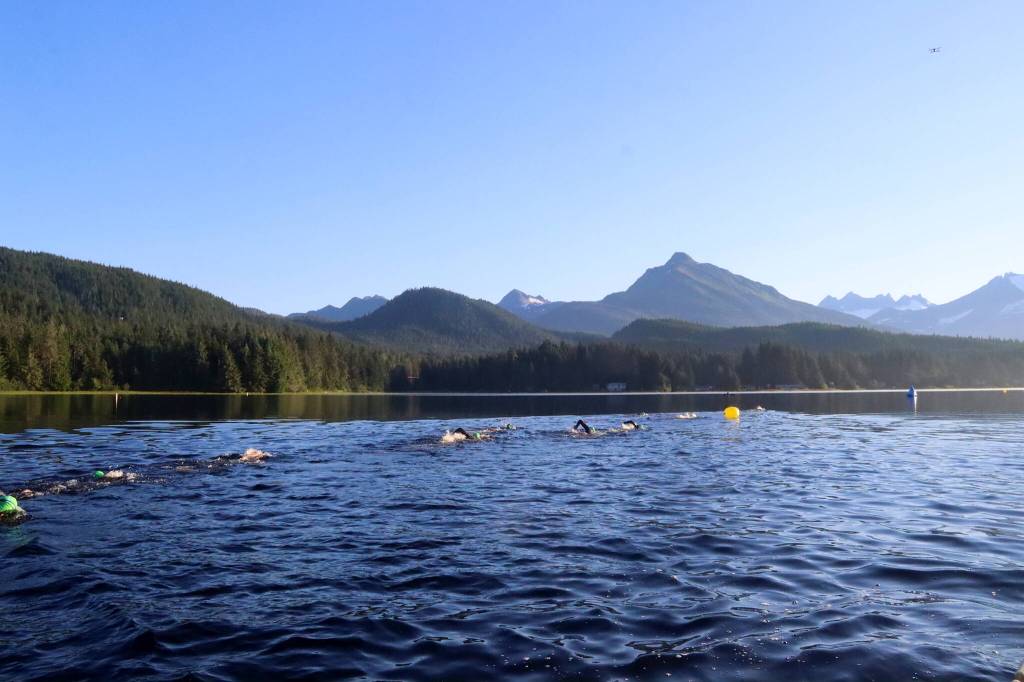 Swimmers head toward buoys marking the race course during the Aukeman Triathlon on Sunday. (Mark Sabbatini / Juneau Empire)