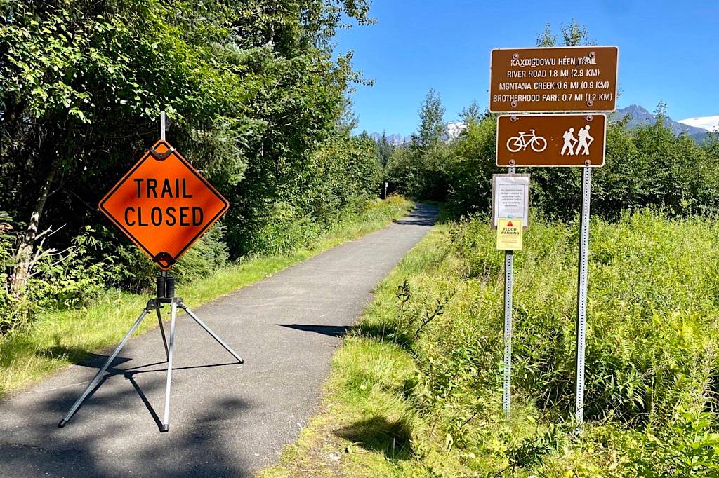 A sign announcing the Kaxdigoowu Héen Dei Trail is closed is posted Monday due to flooding of the Mendenhall River that is expected to crest early Tuesday morning. (City and Borough of Juneau photo)