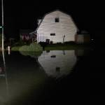 The water level rises rapidly on Meander Way at about 12:30 a.m. Tuesday, about 15 minutes after power was cut off to the neighborhood. (Jasz Garrett / Juneau Empire)