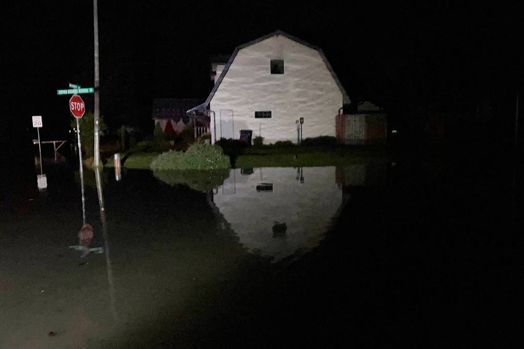 The water level rises rapidly on Meander Way at about 12:30 a.m. Tuesday, about 15 minutes after power was cut off to the neighborhood. (Jasz Garrett / Juneau Empire)