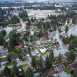Water spills into homes and streets in the Mendenhall Valley following record flooding from the Mendenhall River on Tuesday morning. (Photo by Rich Ross)