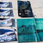 Photos of the Mendenhall Glacier and books about climate change dry outside of Debora Gerrishs house on Tuesday afternoon. (Jasz Garrett / Juneau Empire)