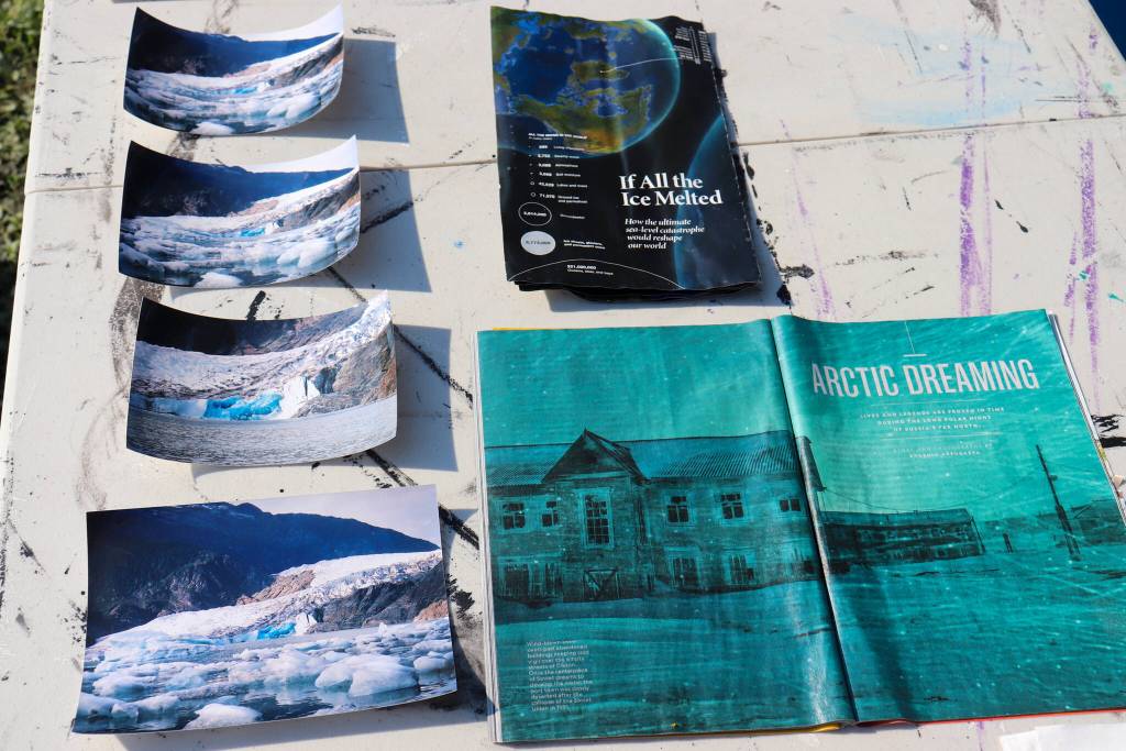 Photos of the Mendenhall Glacier and books about climate change dry outside of Debora Gerrishs house on Tuesday afternoon. (Jasz Garrett / Juneau Empire)