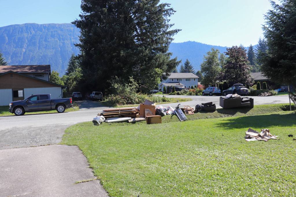 Abner Miller starts putting things out for trash collection on Thursday afternoon. (Jasz Garrett / Juneau Empire)