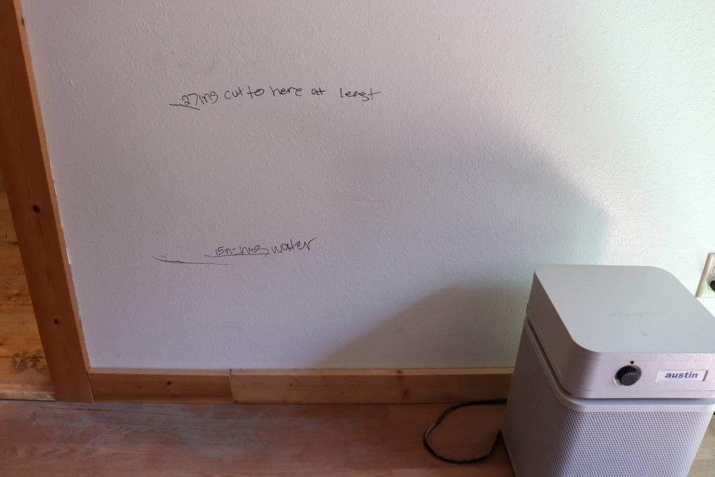 Deboras daughter, Christy Gendron, was helping clean up and mark where water lines were to document the damage and determine up to what level of drywall will need to be removed. (Jasz Garrett / Juneau Empire)