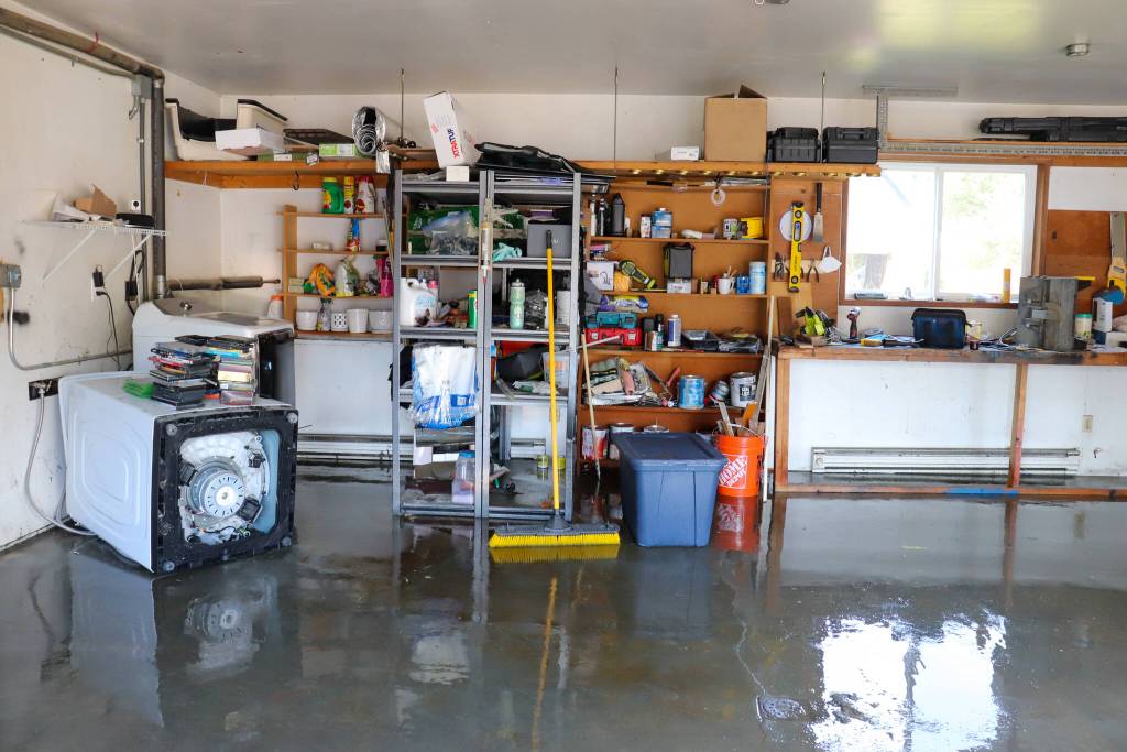 Jessica Nardis garage is seen with water still inside on Tuesday afternoon. She said the flood flipped over her washer on its side. (Jasz Garrett / Juneau Empire)