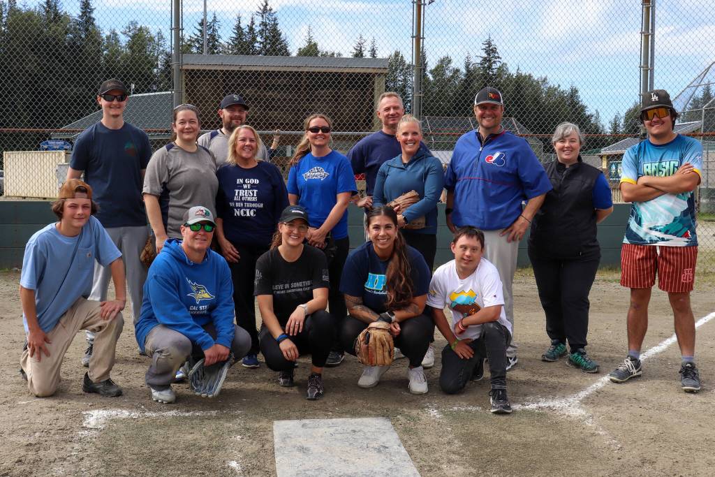 The Juneau Police Department and Alaska State Troopers pose for a team photo following their close game with Capital City Fire/Rescue on Saturday in the Alaska Peace Officer Associations charity softball tournament. The score was 5-4. (Jasz Garrett / Juneau Empire)