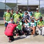 Firefighter Sylvester Olivares-Ramos bows down to give the U.S. Coast Guard softball team their first-place trophy in the Alaska Peace Officer Associations charity softball tournament on Saturday that fundraises for Special Olympics Alaska. (Jasz Garrett / Juneau Empire)