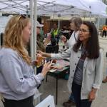 Brenna Heintz explains work being done at the Melvin Park flood recovery center to U.S. Rep. Mary Peltola on Sunday. (Mark Sabbatini / Juneau Empire)