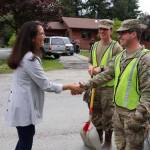 U.S. Rep. Mary Peltola on Sunday greets Alaska Organized Militia members Jacob Miller and Robert Brian, two of the seven Juneau AKOM members and 60 statewide that are assisting with flood recovery efforts. (Mark Sabbatini / Juneau Empire)