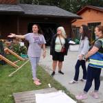 Tesla Cox (left) explains the damage done to her home and possessions by a record flood to a delegation of leaders on Sunday including (from left in foreground) Tlingit and Haida Regional Housing Authority President Jacqueline Pata, U.S. Rep. Mary Peltola, Tlingit and Haida Tribal Emergency Operations Center Incident Commander Sabrina Grubitz, and Juneau state Rep. Sara Hannan. (Mark Sabbatini / Juneau Empire)