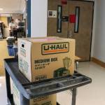 Kristen Wells, science teacher at Juneau-Douglas High School: Yadaa.at Kalé, moves boxes into her Project Lead the Way: Intro to Engineering Design classroom on Monday. (Jasz Garrett / Juneau Empire)