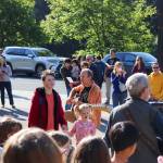 Chase Van Linden and Eliana Porter sing The Golden Goats, the school song of Montessori Borealis, during the 33rd annual Wisdom Day on Thursday. (Jasz Garrett / Juneau Empire)