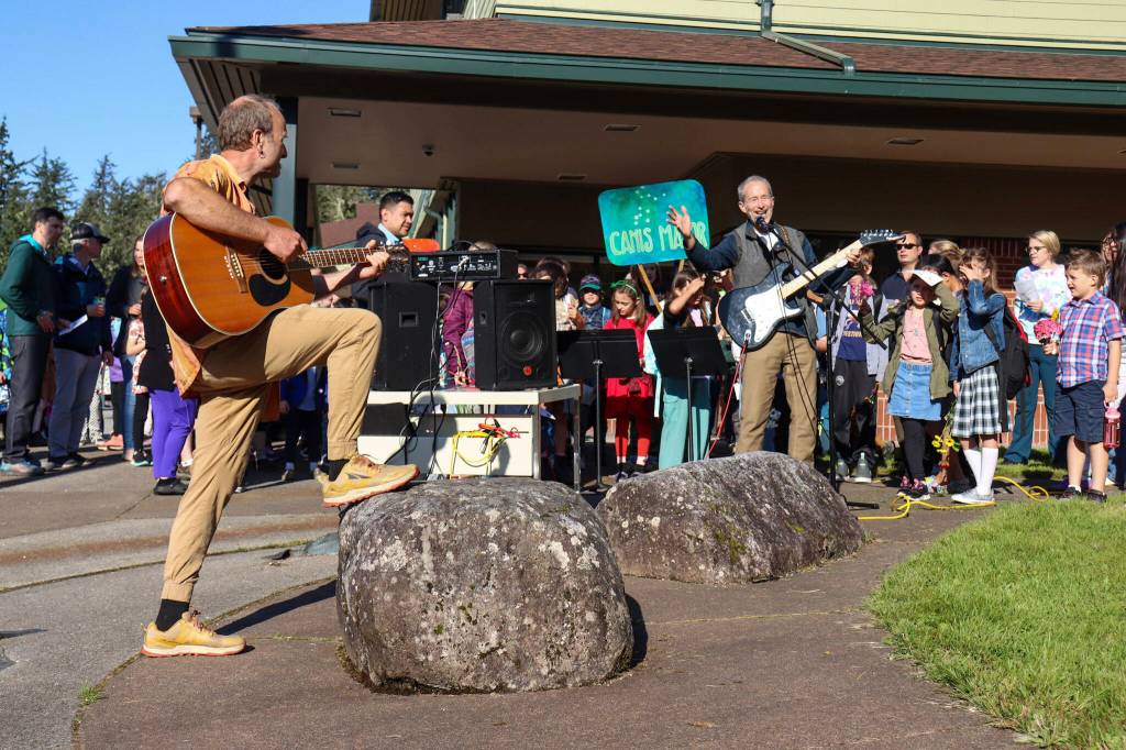 Rick Trostel (right) a music teacher at Montessori Borealis and founder of the school, leads Montessori Borealis through the song Alaskas Flag on Thursday morning before the start of school. (Jasz Garrett / Juneau Empire)