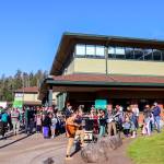 School buses arrive at the Dzantiki Heeni campus on Thursday morning as Montessori Borealis Public Alternative School begins its 33rd annual Wisdom Day. (Jasz Garrett / Juneau Empire)