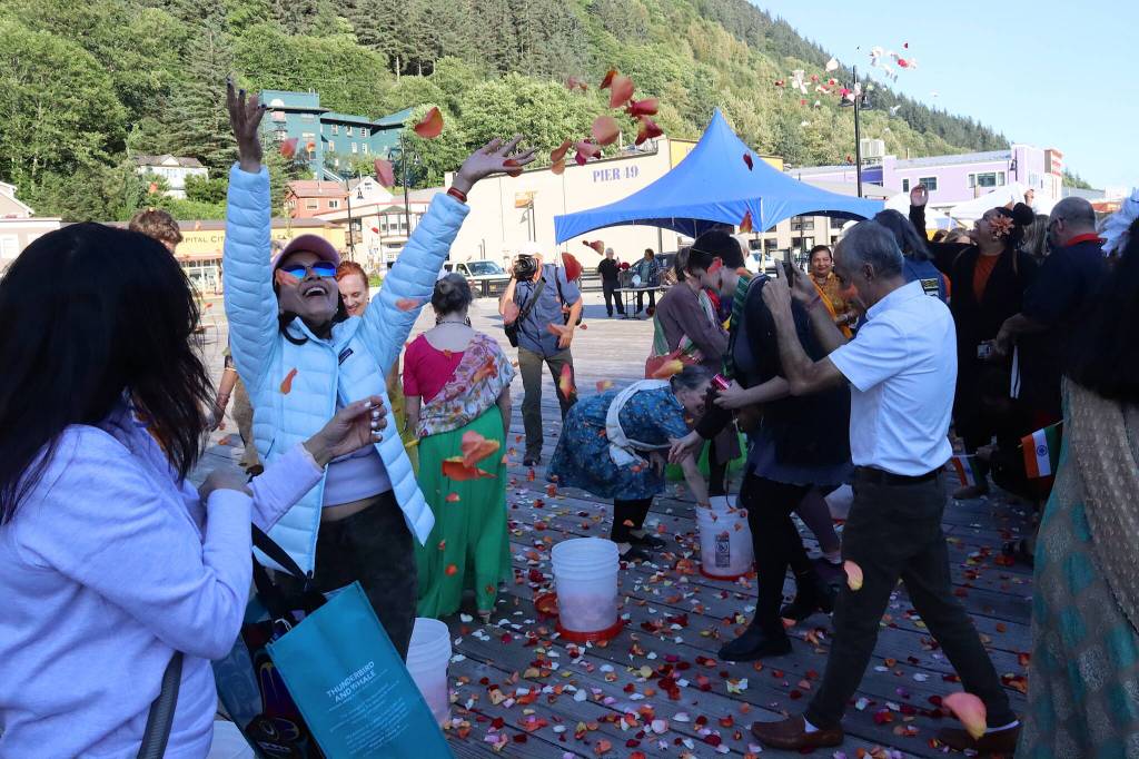 People throw rose petals in the air during a celebration of Indias Independence Day on Friday at Elizabeth Peratrovich Plaza. (Mark Sabbatini / Juneau Empire)