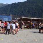 Members of the girls cross-country team at Juneau-Douglas High School: Yadaa.at Kalé (left) and alumni of local cross-country teams form separate rally circles before the womens 5K race of the Sayéik Invitational at Savikko Park on Saturday morning. (Mark Sabbatini / Juneau Empire)